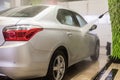 Car wash. Cleaning high-pressure water cars and foam in the washing station Royalty Free Stock Photo