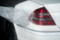 Car Wash Closeup. Washing Car by High Pressure Water Royalty Free Stock Photo