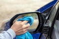 car wash and interior chemical cleaning concept.woman hand use microfiber cloth and spray to clean Royalty Free Stock Photo