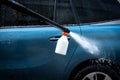 Car wash process. Spray foam bubble shampoo on the car surface Royalty Free Stock Photo