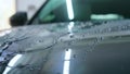 At the car wash, after washing, water drops and wax flow down the windows. Concept of: Window cleaning, Special Cleaning products, Royalty Free Stock Photo