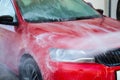 Car washing. Cleaning car using high pressure water Royalty Free Stock Photo