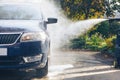 Car washing with pressure washer on backyard Royalty Free Stock Photo