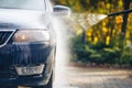 Car washing with pressure washer on backyard Royalty Free Stock Photo