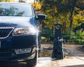 Car washing with pressure washer on backyard Royalty Free Stock Photo
