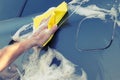 Car washing with a yellow sponge Royalty Free Stock Photo
