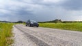 Car on the way among green fields in Phrygia Valley Natural Park Frig Vadisi Tabiat Parki, Ihsaniye, Afyonkarahisar/Turkey Royalty Free Stock Photo