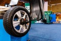 A car wheel on an automated car wheel balance machine in the garage Royalty Free Stock Photo