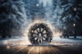 a car wheel on the background of a winter road and a beautiful night landscape, a snow-covered forest with lights, a concept Royalty Free Stock Photo