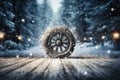a car wheel on the background of a winter road and a beautiful night landscape, a snow-covered forest with lights, a concept Royalty Free Stock Photo