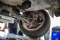 A photograph of mechanics performing a car wheel balancing and spurring at a service garag Royalty Free Stock Photo