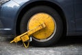 Car wheel blocked by wheel lock because illegal parking violation Royalty Free Stock Photo