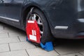 Car wheel clamp Locked illegally parked cars Car wheel blocked by wheel lock because of illegal parking violation. Wheel Royalty Free Stock Photo