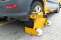 Car wheel clamp on street for illegal parking Royalty Free Stock Photo
