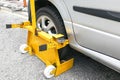 Car wheel clamp on street for illegal parking Royalty Free Stock Photo