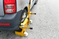 Car wheel clamp on street for illegal parking Royalty Free Stock Photo