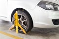 Car wheel clamped for illegal parking violation at car park Royalty Free Stock Photo