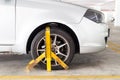 Car wheel clamped for illegal parking violation at car park Royalty Free Stock Photo