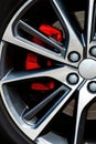 Car wheel close-up with a bright red sports caliper Royalty Free Stock Photo