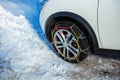 Car wheel close-up from side with winter chains for snow Royalty Free Stock Photo