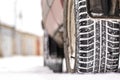 Car wheel close-up of the tread is clogged with snow