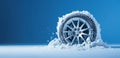 A car wheel covered in snow and ice studio shot against blue, Winter driving and travel