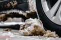 Car wheel with dirty stuck snow. Winter problems for drivers. Royalty Free Stock Photo