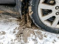 Car wheel and door with snow stuck to them. Snow cleaning from mudflaps Royalty Free Stock Photo