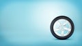 A car wheel with five spokes standing on the tire rim on blue background. Royalty Free Stock Photo