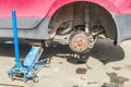 Car without wheel lift up by hydraulic, waiting for tire replacement