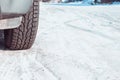 A car wheel on a slippery winter road. Close- up of studded rubber on ice. Dangerous driving conditions. Icy road with tracks from Royalty Free Stock Photo