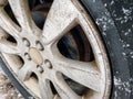 Car wheel with snow stuck to it. Closeup view. Rusted drum brakes Royalty Free Stock Photo