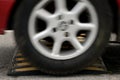 Car wheel and speed bumps closeup