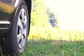 Car wheel with summer tires close-up on green grass