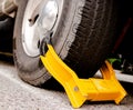 Dramatic car tire with yellow boot Royalty Free Stock Photo