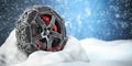Car wheel with winter tire and snow chain in snow Royalty Free Stock Photo