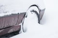 Car wheel with winter tires in the snow. Wheel stuck in a snowdrift. Snow drifts on road, bad weather Royalty Free Stock Photo