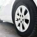 Car wheels close up on a background of asphalt. White car