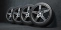 Car wheels. Four new black tyres with alloy discs in garage Royalty Free Stock Photo