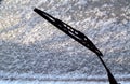 Car whiper blade and snow on glass with blur effect Royalty Free Stock Photo