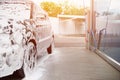 car in white cleaning foam at car wash Royalty Free Stock Photo