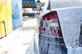 Car in white foam on a manual car wash. Gray car washed in white foam. Car at the car wash Royalty Free Stock Photo