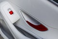 Car white leather interior details of door handle with windows controls and adjustments. Car window controls of modern car Royalty Free Stock Photo