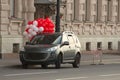 Car with white and red balloons