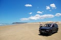 Car at white sand beach