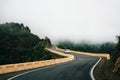 Car is on winding road in mist in Tenerife Royalty Free Stock Photo