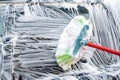 Car window covered with foam being wiped with a brush on the self service car wash