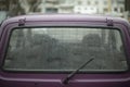 Car window is lighter in rain. Wet car in parking lot. Details of old transport Royalty Free Stock Photo