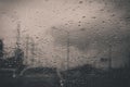 Car window with rain drops on glass or the windshield,Blurred traffic on rainy day in the city Royalty Free Stock Photo