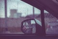 Car window with rain drops on glass or the windshield,Blurred traffic on rainy day in the city Royalty Free Stock Photo